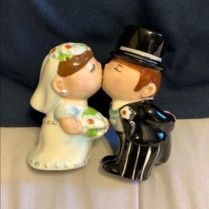 Salt and Pepper kissing bride and groom